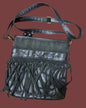 Sac à main en cuir noir avec pompons
